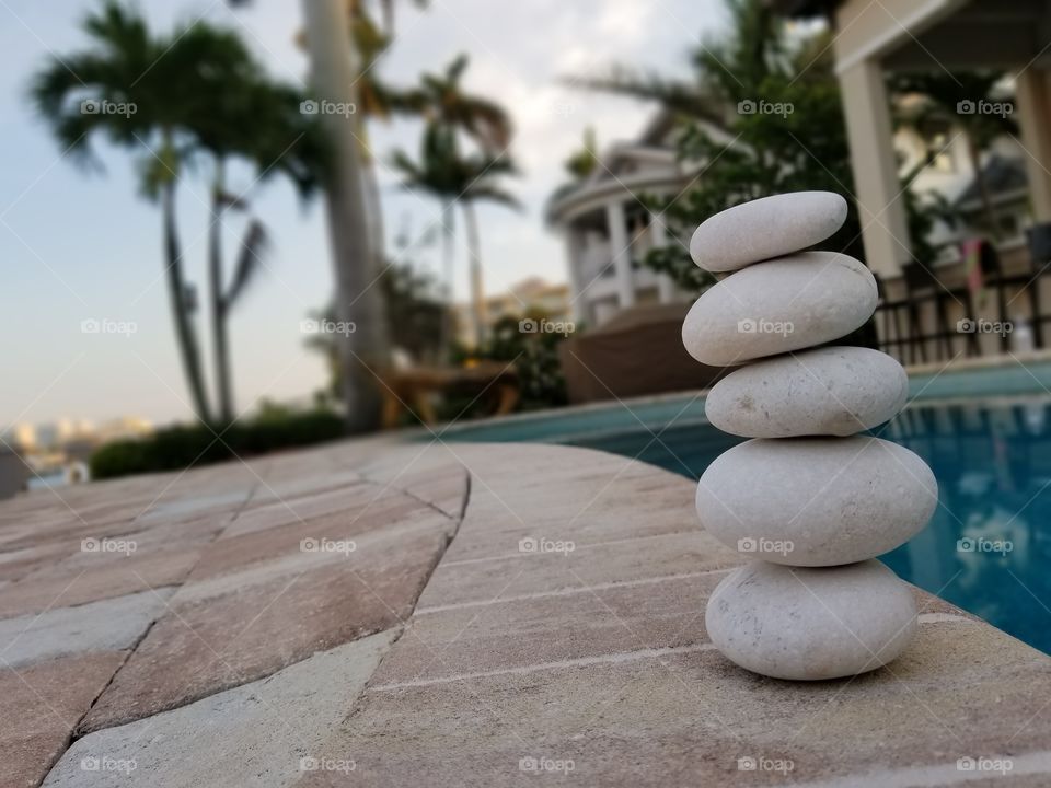Family vacation in Florida. stacking rocks by the pool. very peaceful.