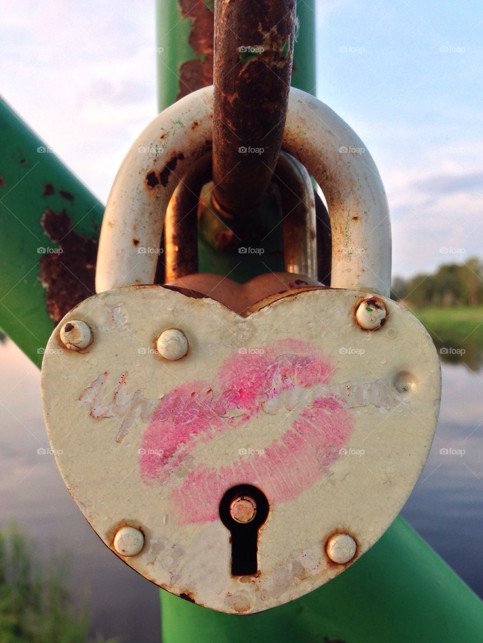 Love padlock with pink kiss tied on bridge rail, Valga Estonia