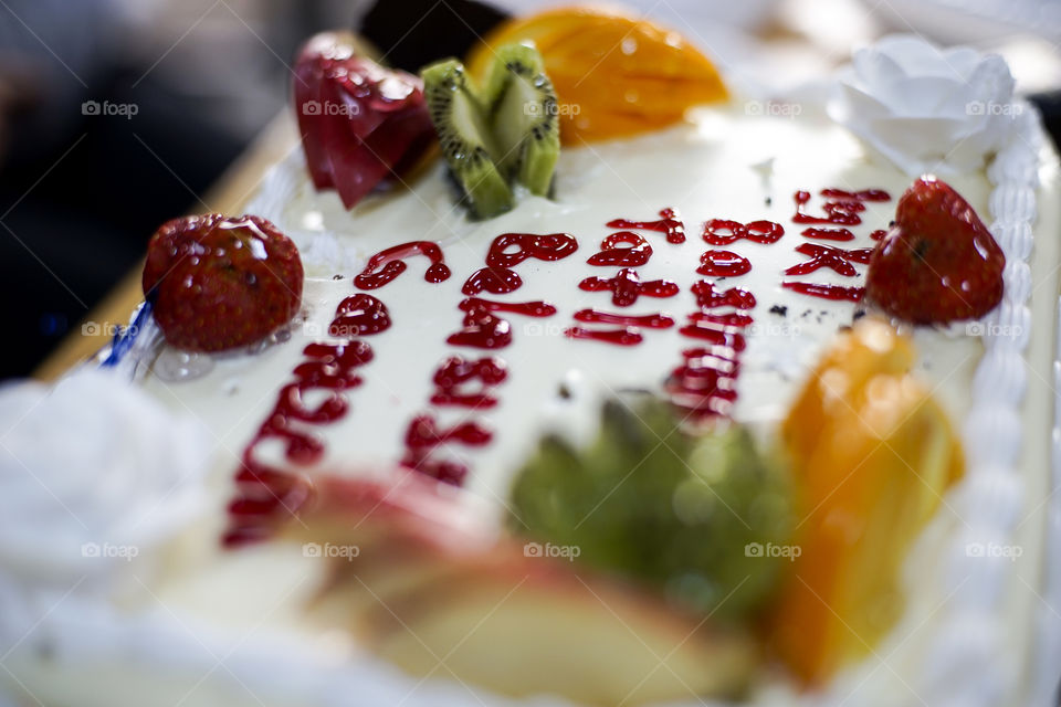 orange kiwi strawberry cake, cream on top article