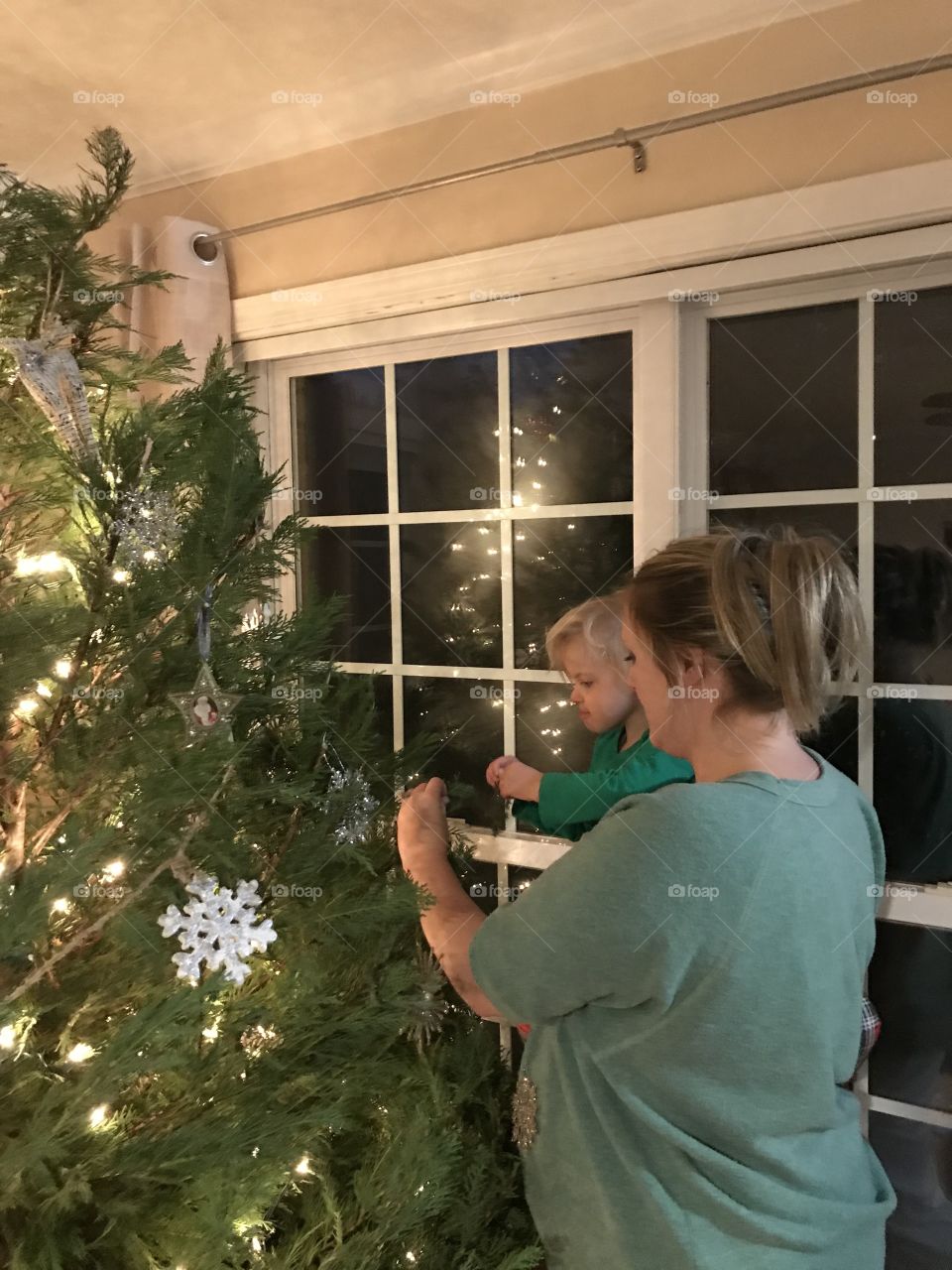 Mommy helping hang an ornament