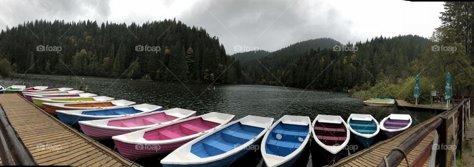 Colorful boats on the lake in forest.