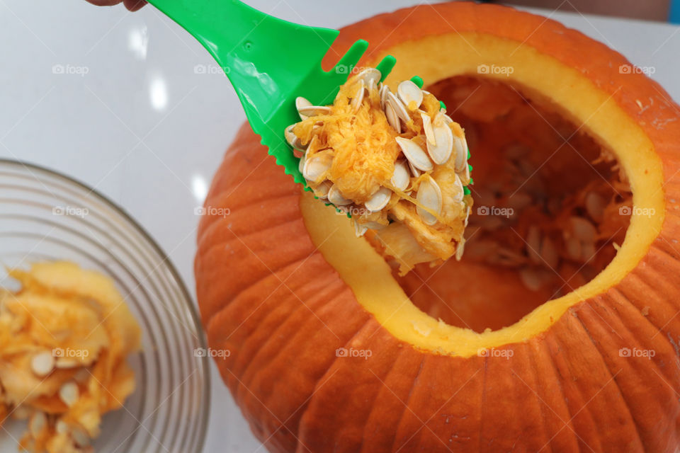 Cleaning out a pumpkin for carving