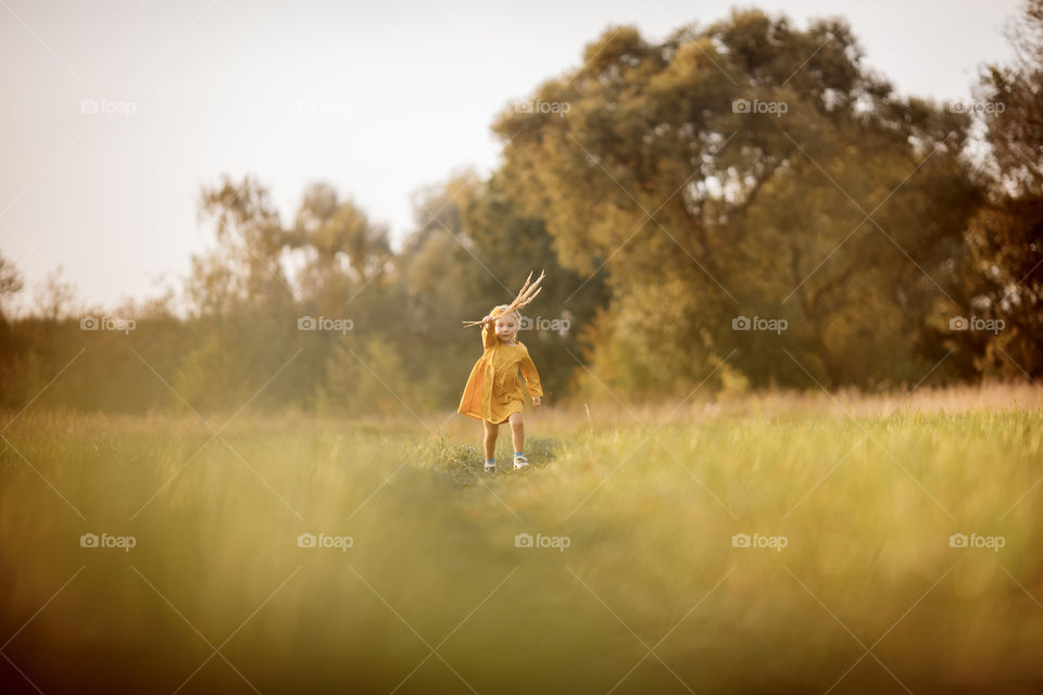 Little girl in yellow dress outdoor portrait 