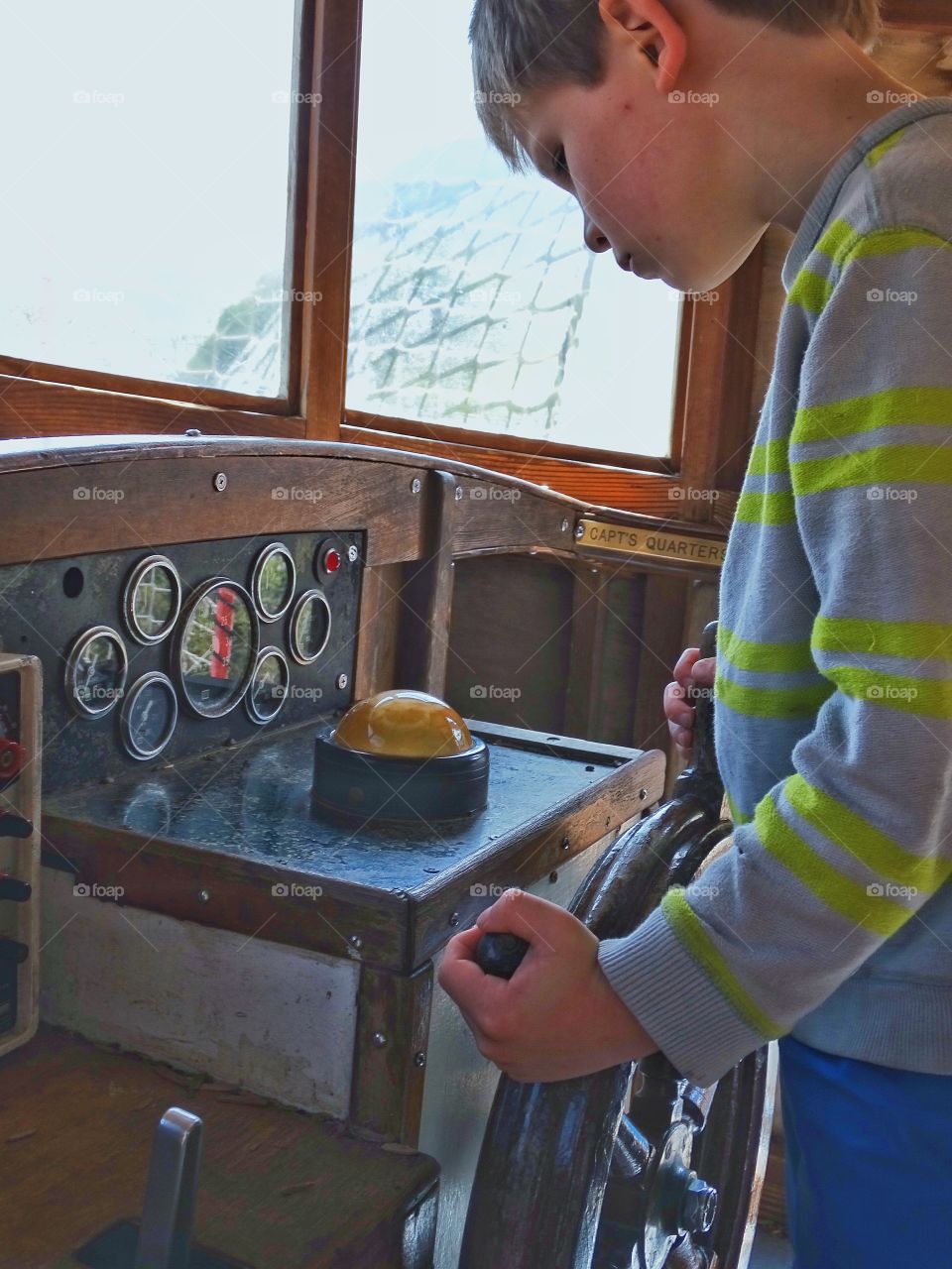 Steering A Boat. Boy Steering A Boat By Compass
