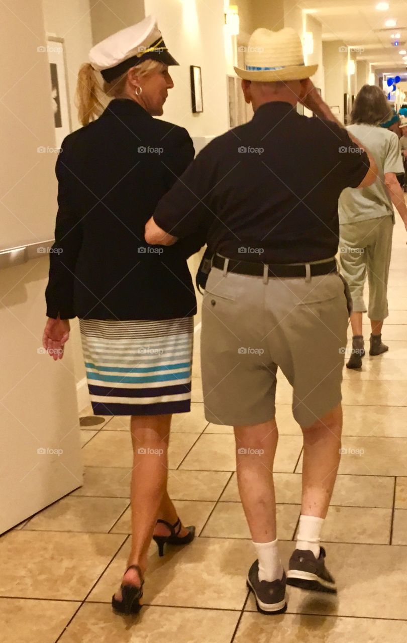 Young woman in sailor clothing with elderly man