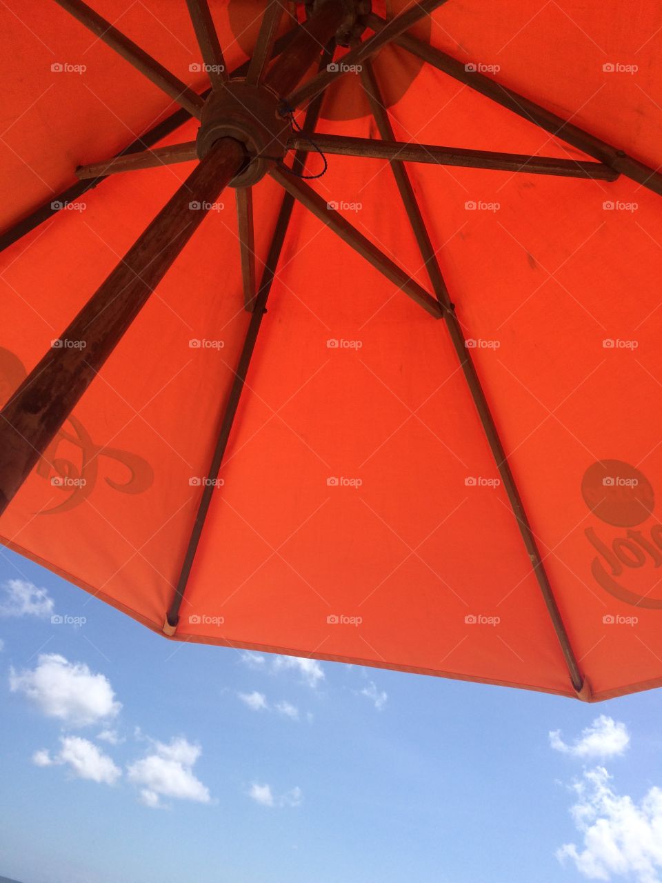 Orange Umbrella, Partly Cloudy Blue Sky
