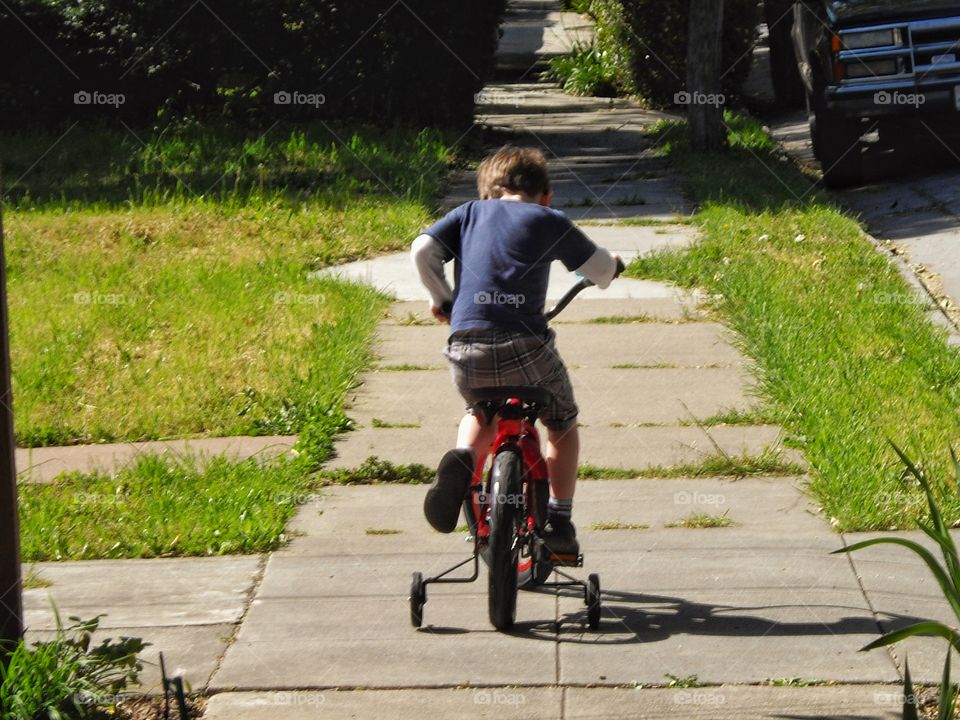 Young Boy Riding A Bike
