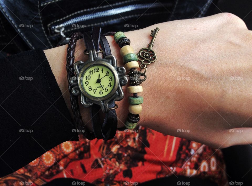 Sitting on the bus, looking at the watch. The bracelet was bought at an artisanal fair. The photo was taken at Rio de Janeiro. 