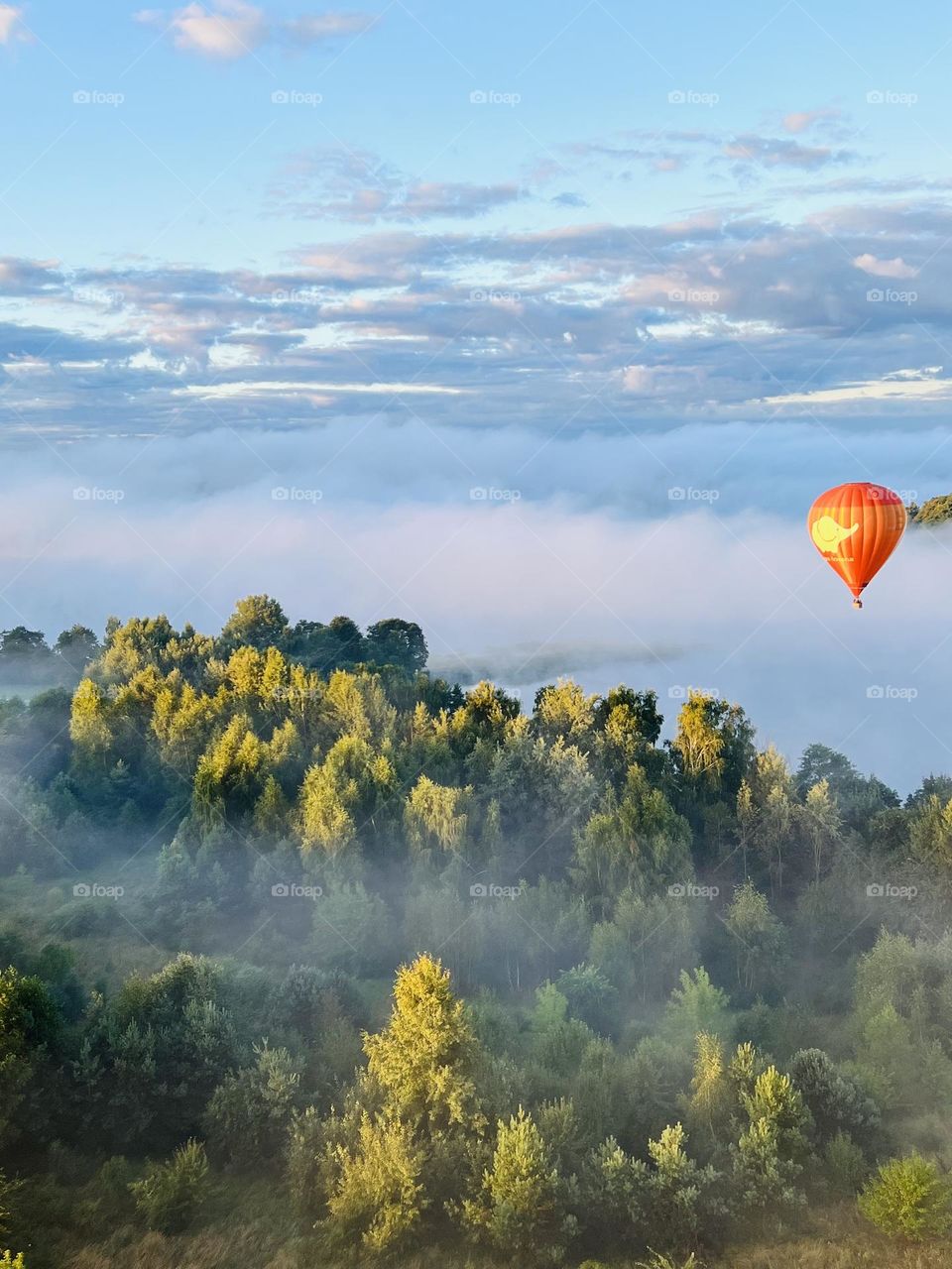 Hot air balloon ride above foggy Trakai in Lithuania