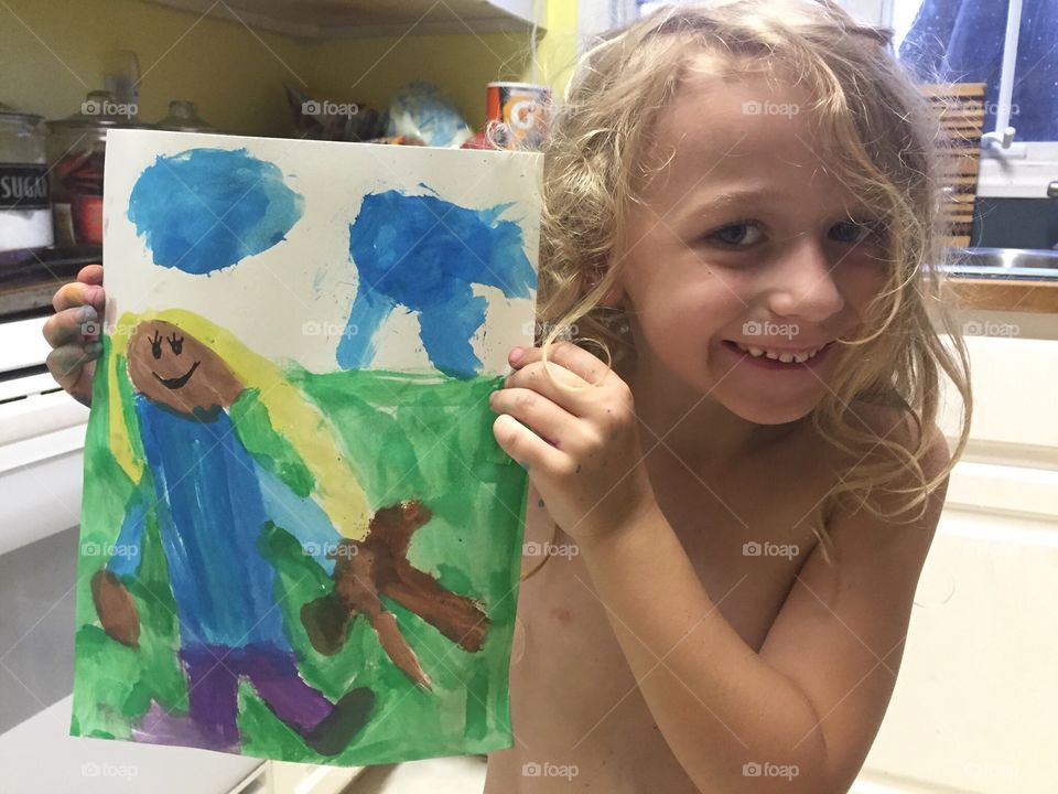My adorable daughter proudly displaying her painting. 
