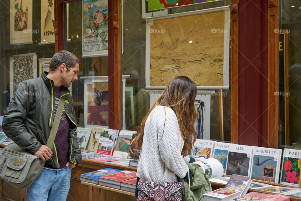 Man and woman looking at books exhibition