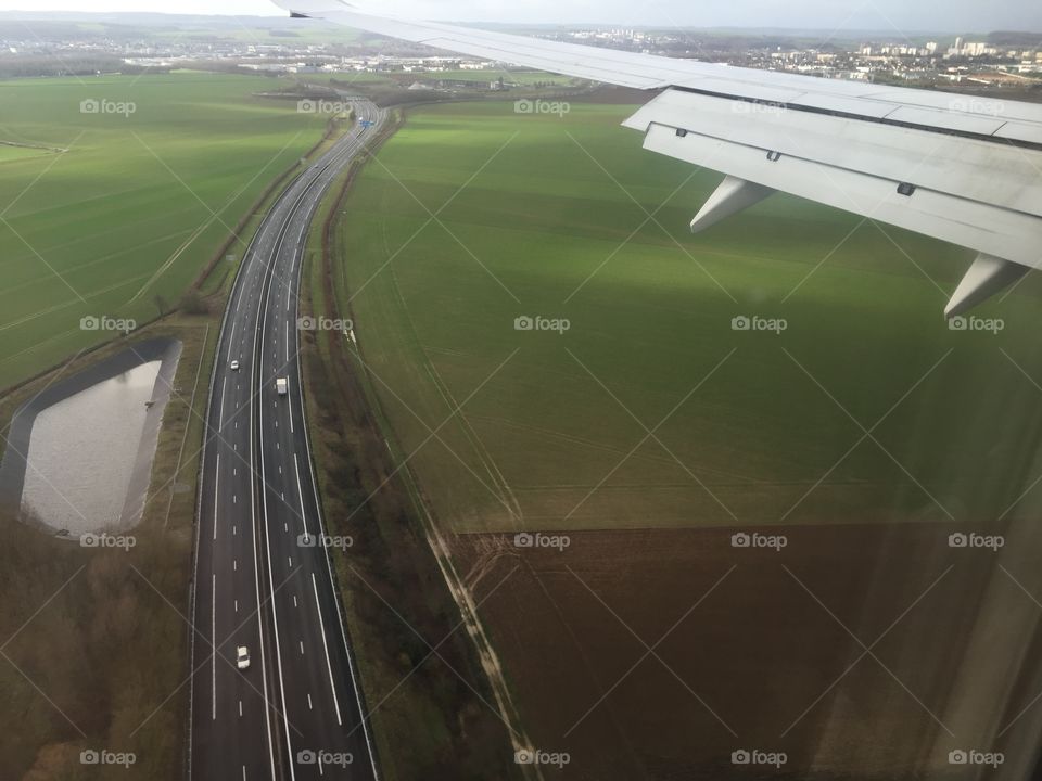 Landscape seen from a plane that is flying at low altitude on a highway