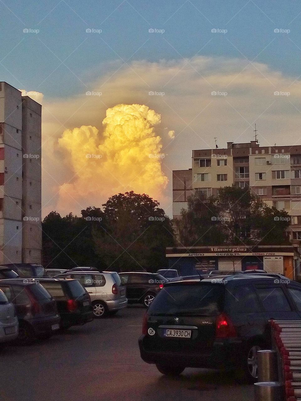 Beautiful sunset clouds in the capital of Bulgaria with vibrant colours, interesting shapes of the clouds, apartment buildings and cars