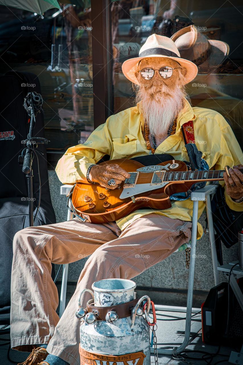 Old fellow making beautiful street music.