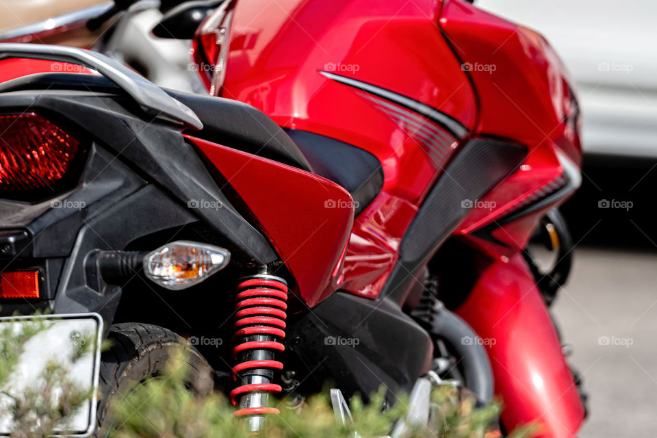 red modern motorcycle close-up, focus on shock absorber, selective focus