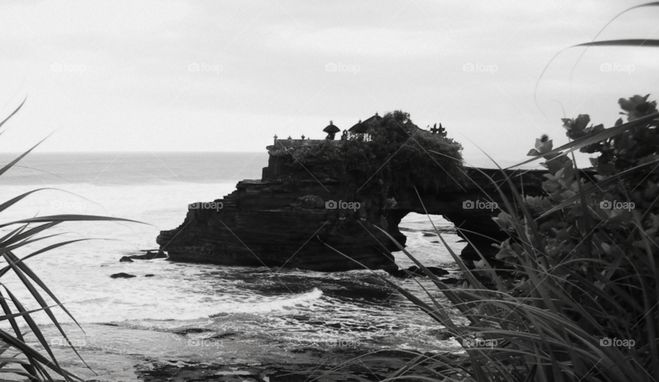 this island called Tanah Lot is the famous place in Bali where most of Hinduism Balinese people are going to the temple up there for worshipping.