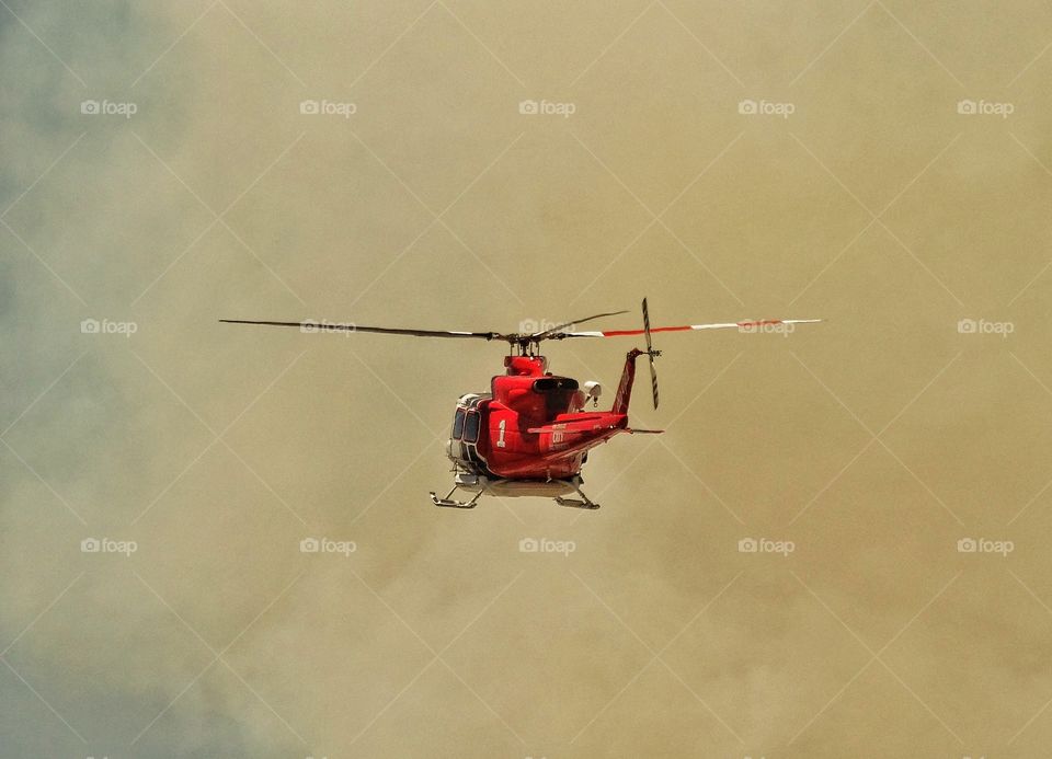 Firefighting Helicopter. Helicopter Fighting A Forest Wildfire
