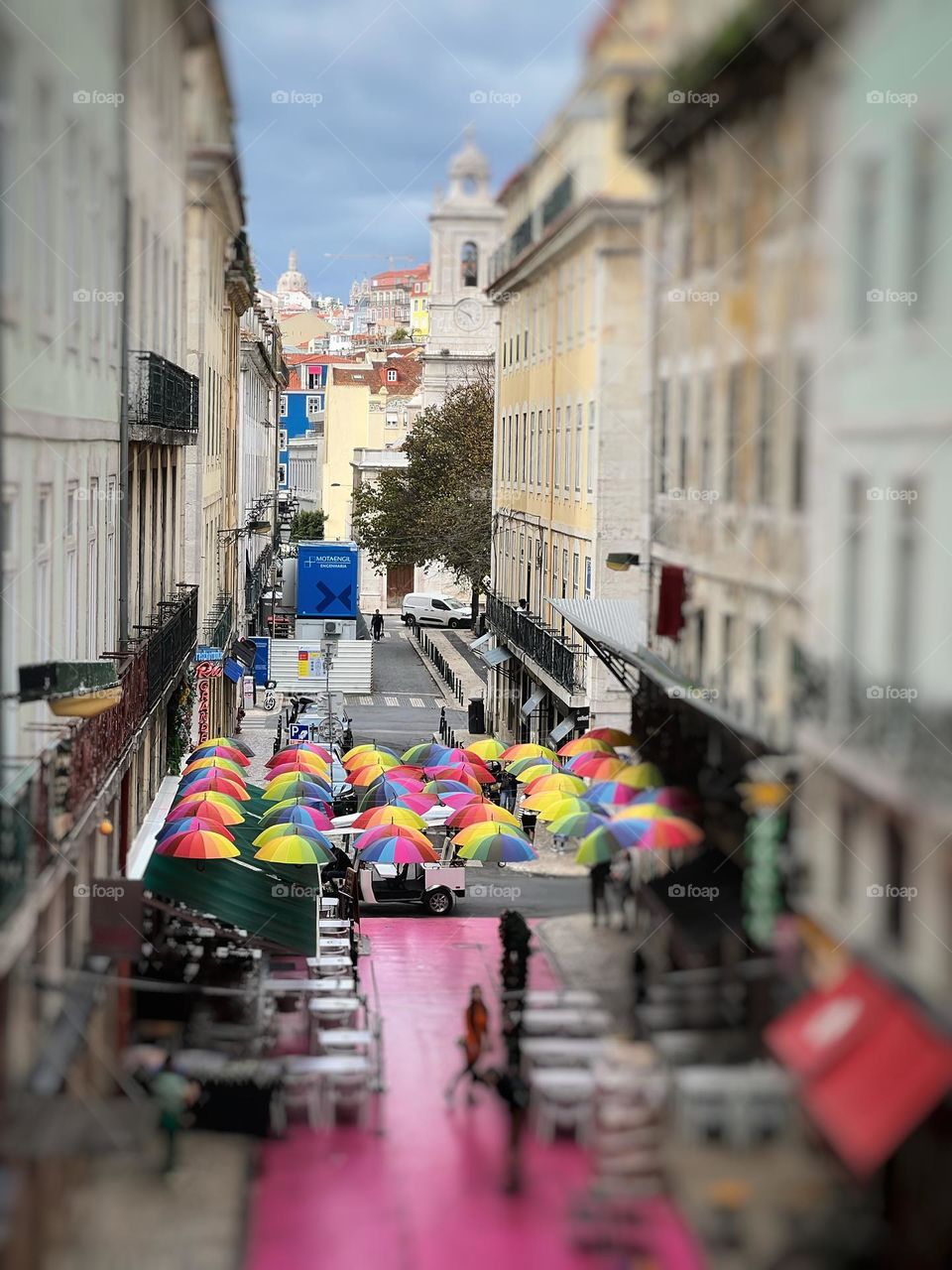 Colourful umbrellas between buildings 