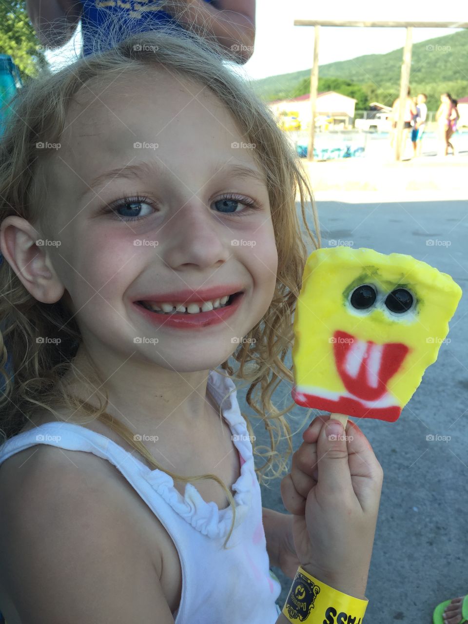 Little girl holding popsicle in hand