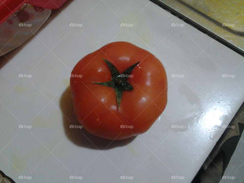 One fresh and clean tomato