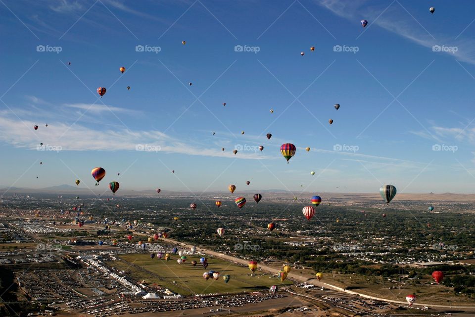 Air view of many hot air balloons over desert at Albuquerque hot air balloon fiesta New Mexico 