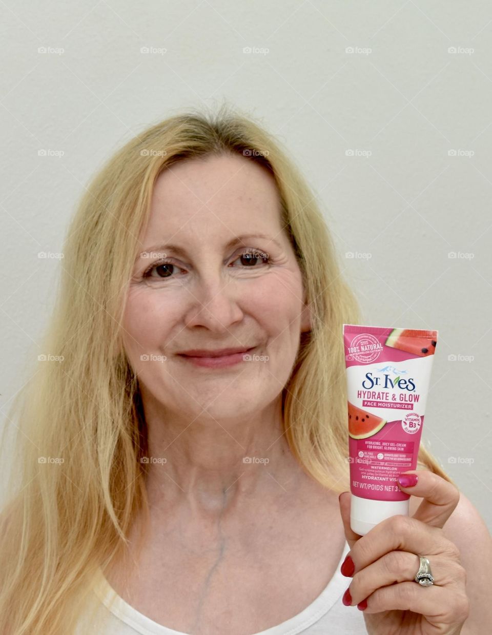 Woman holding St Ives lotion