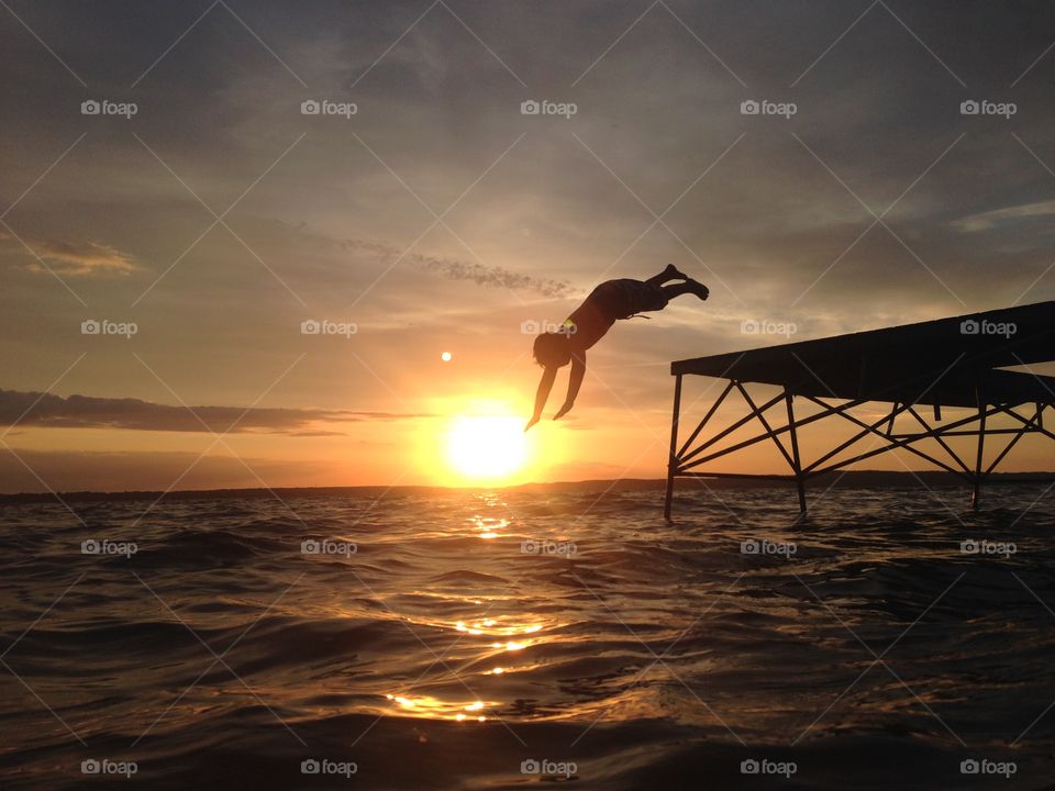 Diving. Kid Diving in sunset 