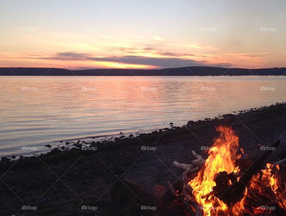 Bonfire on the beach. Summer night at sunset. Dusk.