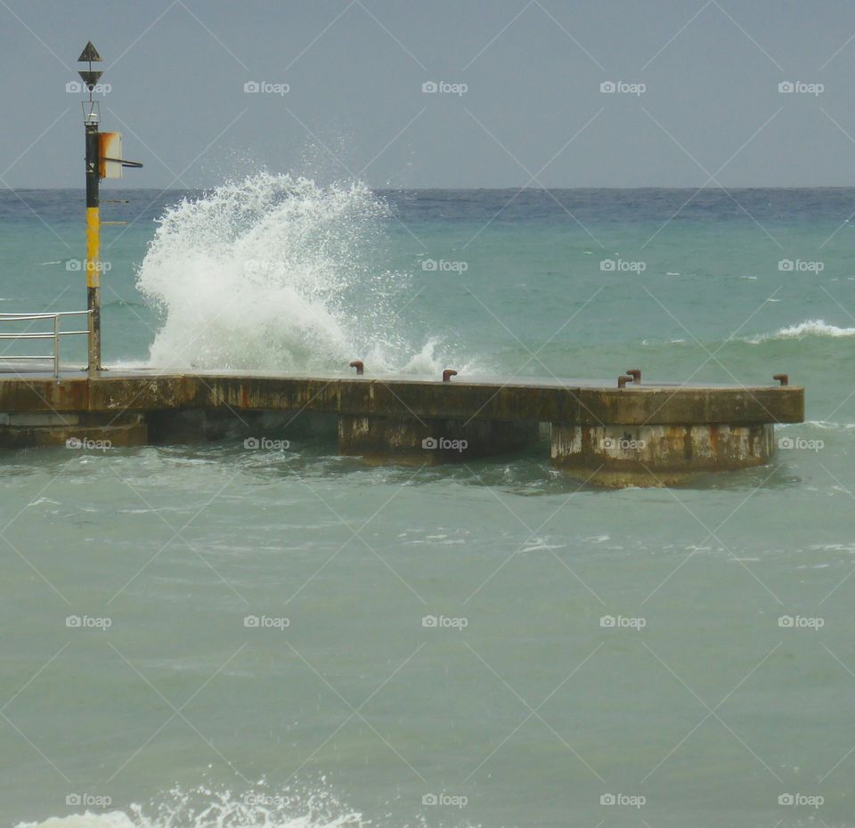 Wave splash in on the pier