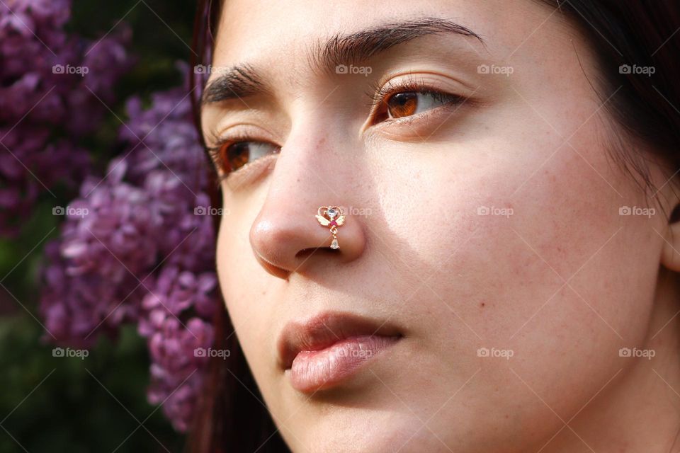 Nose piercing jewellery on a beautiful young woman