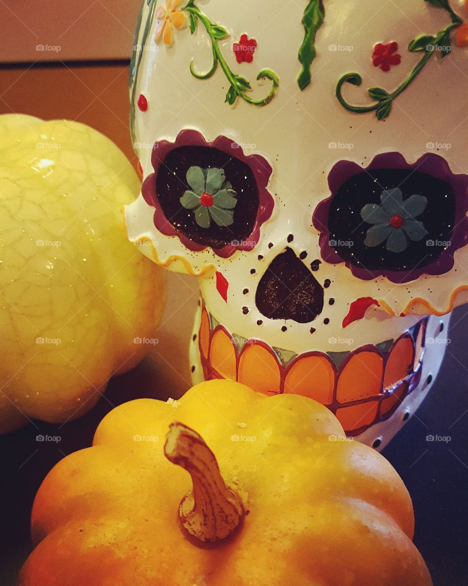 Sugar skull and pumpkins welcome Halloween in a cute way.