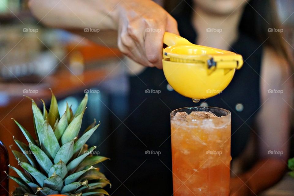 Liquids are cool - A bartender mixes fancy drinks - mixologist a professional well versed in the culinary art of making cocktails and mixed alcoholic drinks