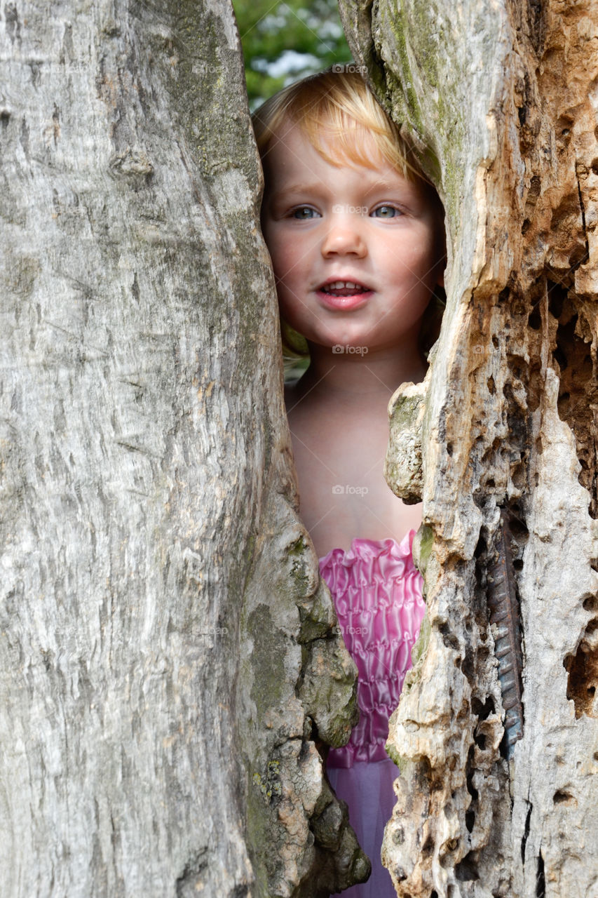 Cute baby standing near tree