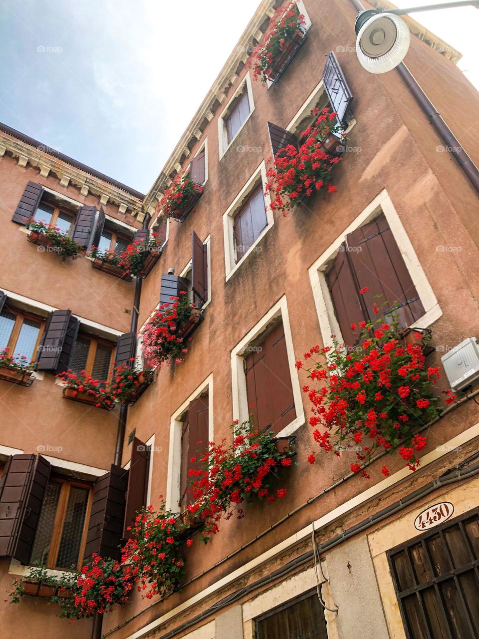 Rectangle shapes of windows and wooden shutters in the building in Venice Italy