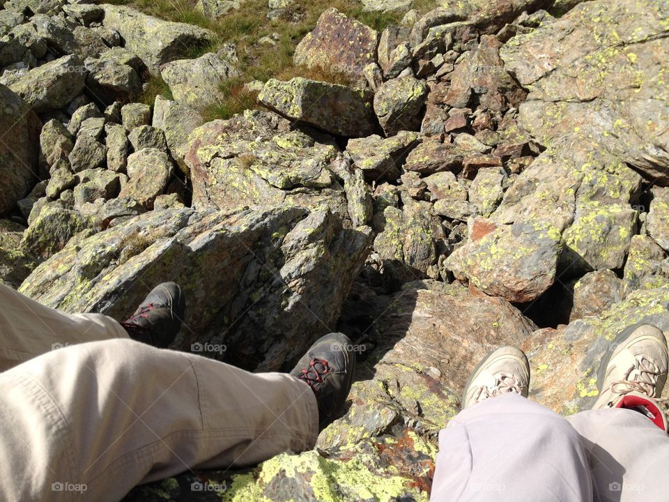 With his feet suspended in the cliff