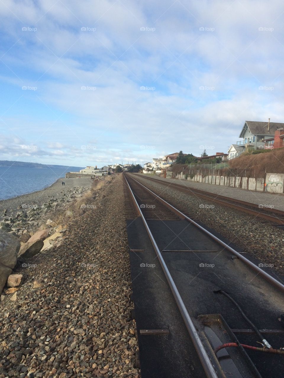 A rail road in Seattle going along the coast.