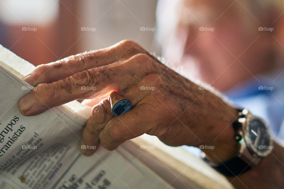 Aging Hands with a Newspaper