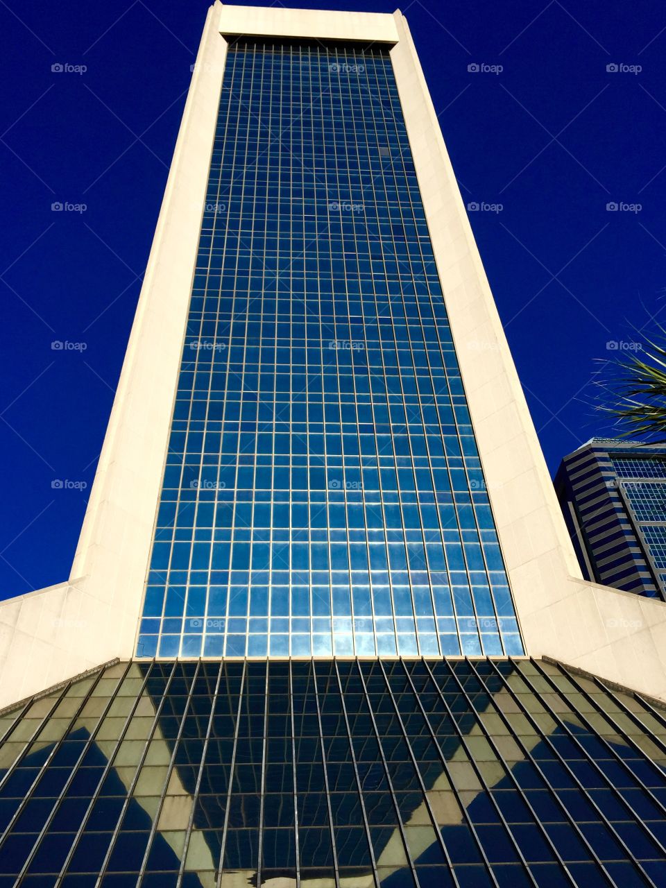 Building Reflects Itself. Building in downtown Jacksonville lower floors windows are at an angle and reflects upper part of skyscraper.