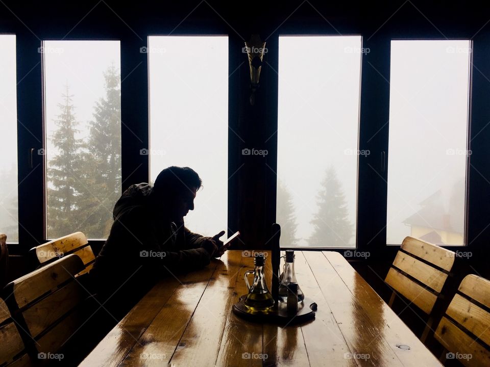 Silhouette of man at the table