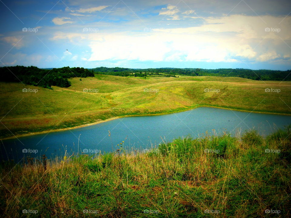 A very pretty scene of a pond in a field in Vinton, Ohio