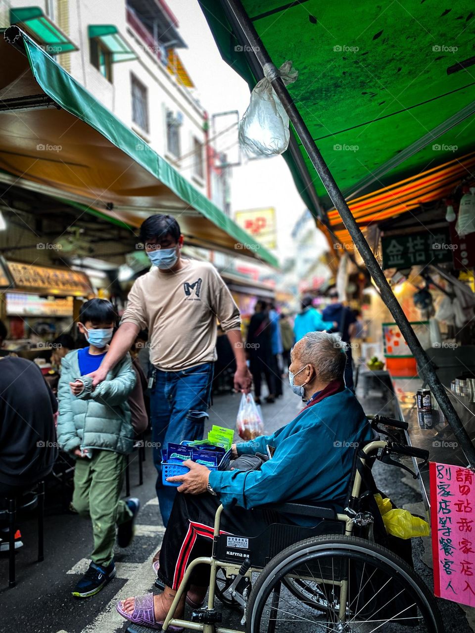 Old man selling chewing gum in the vegetable market