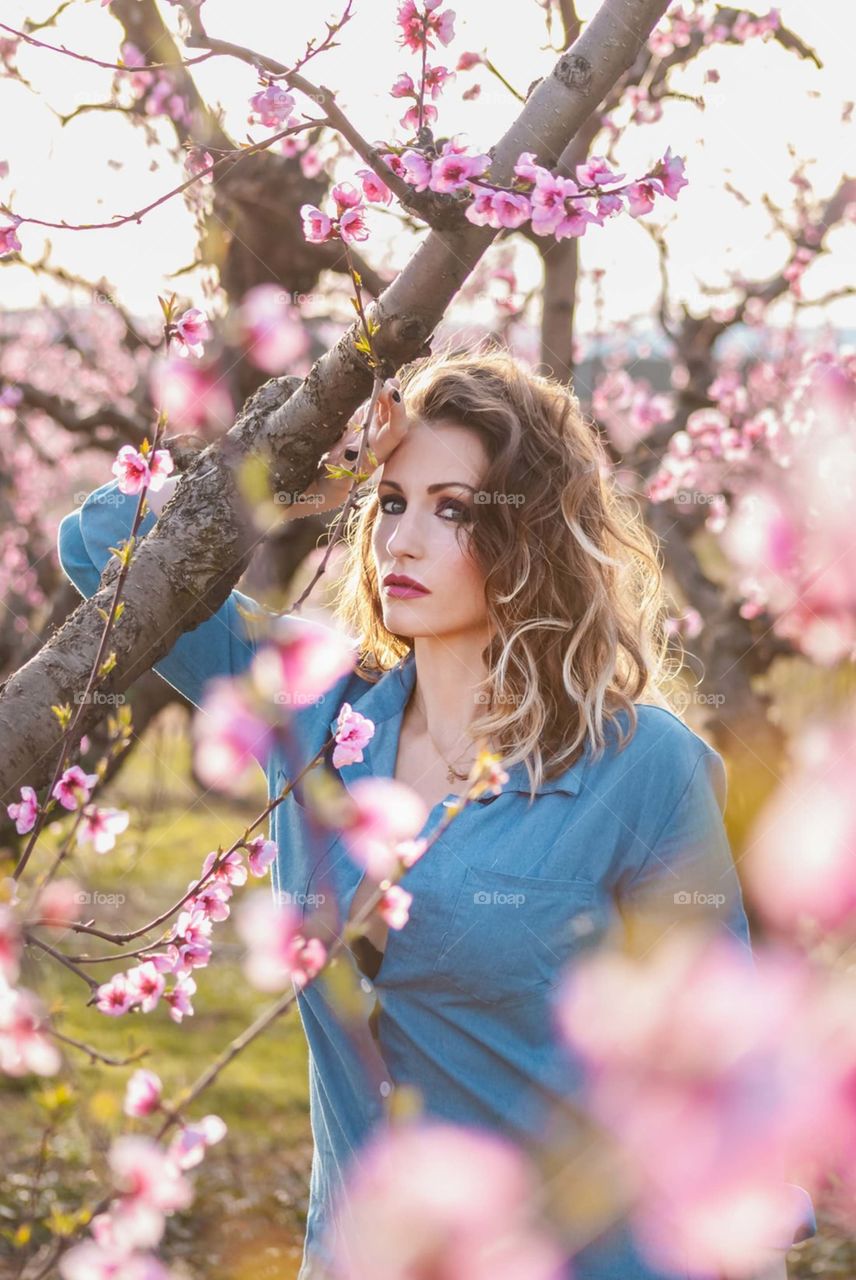 woman under pink cherry blossom