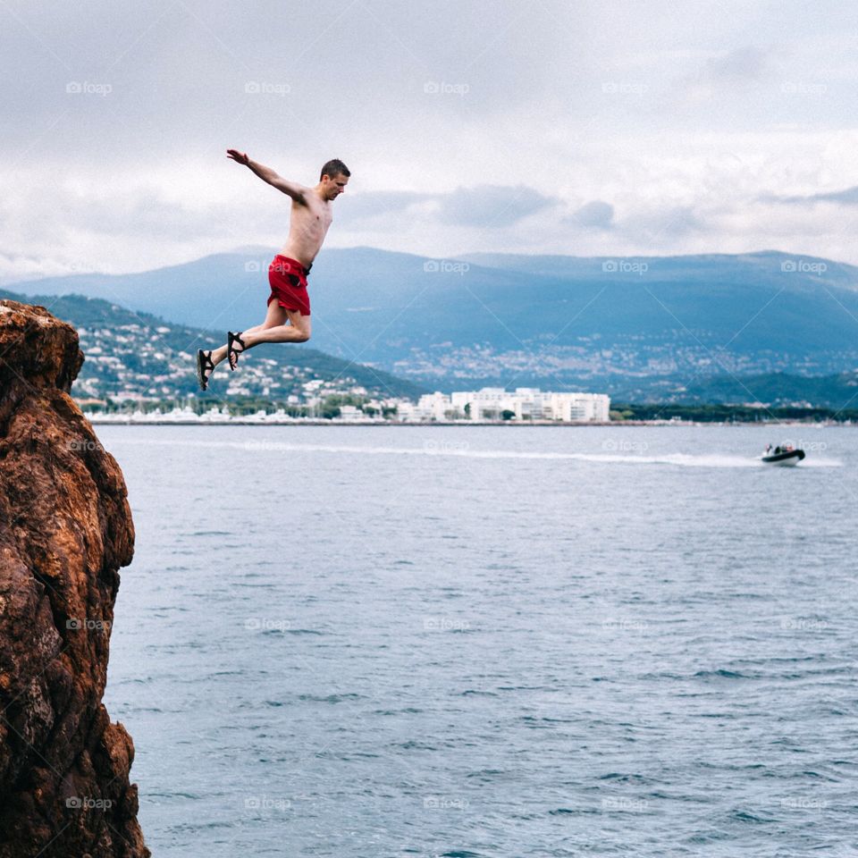 Cliff jumping in the French Riviera into the Mediterranean Sea. Cliff diving jumping into the Mediterranean Sea. 