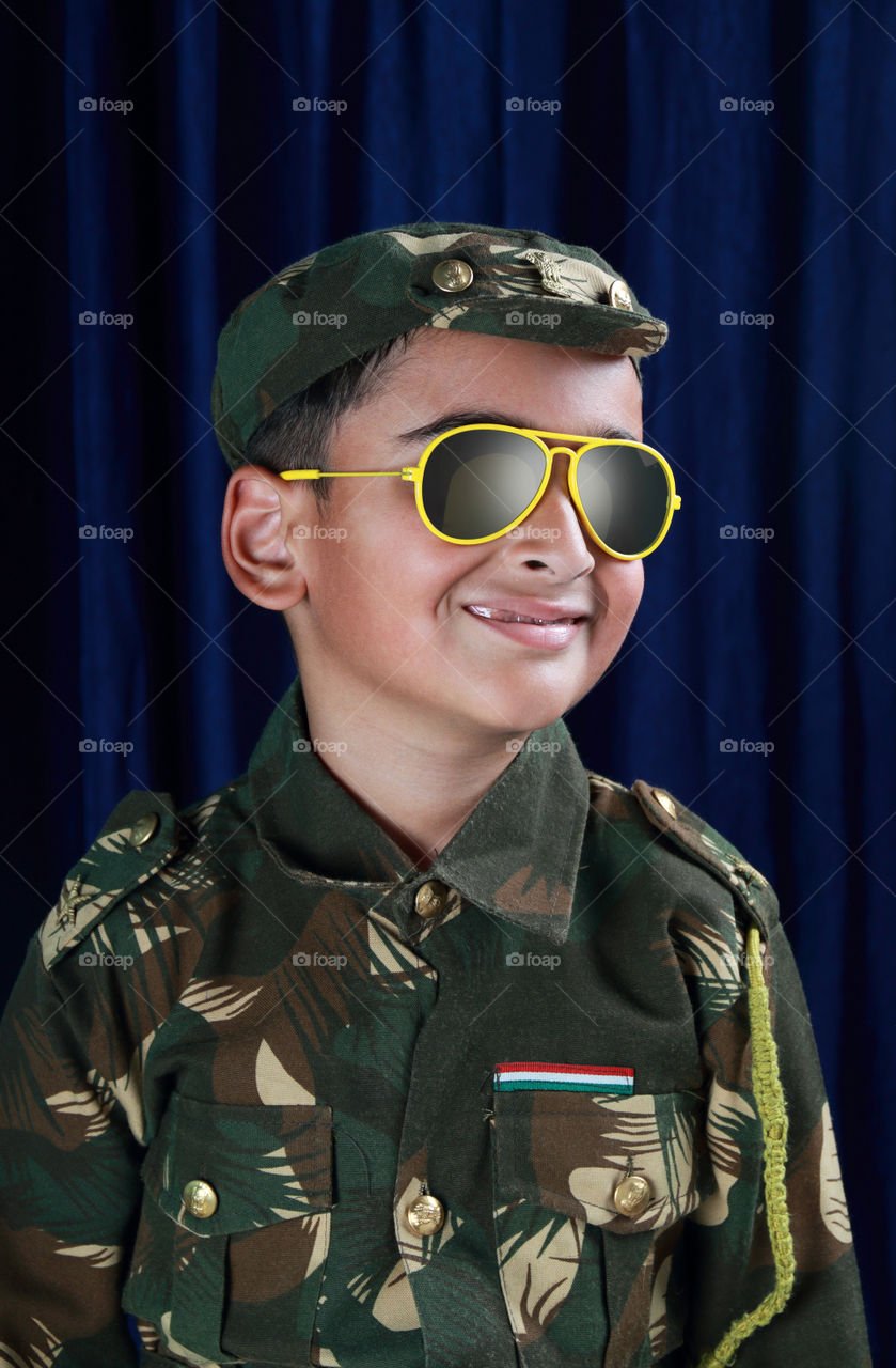 Indian / Asian child kid in a soldier's uniform school fancy dress competition