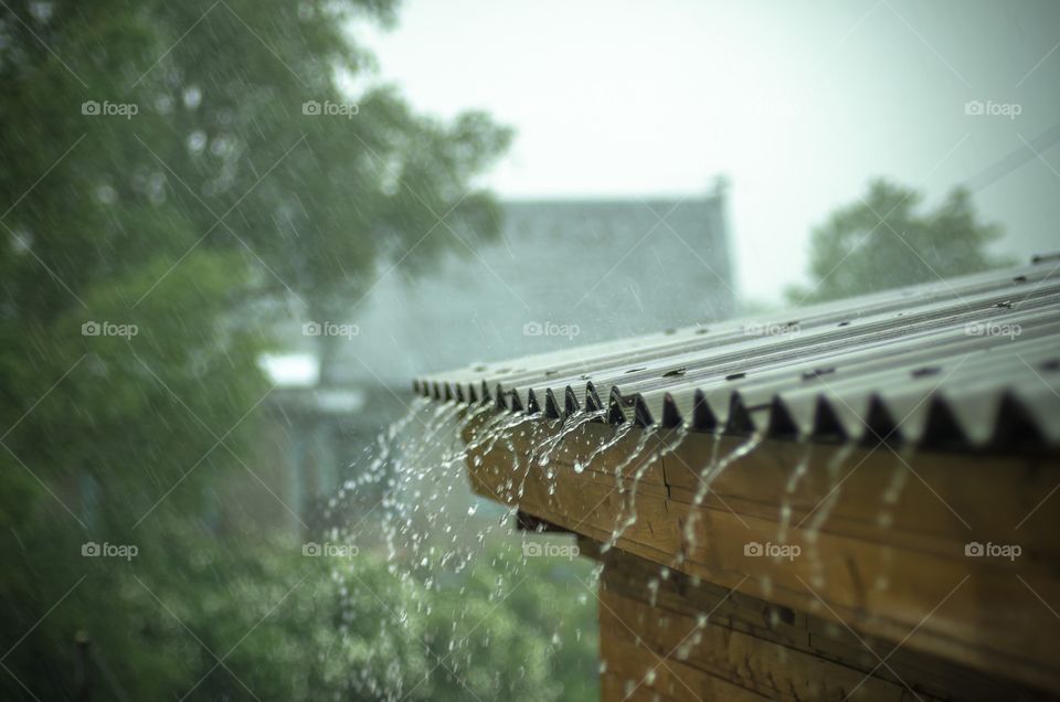 Heavy rain pours from the roof