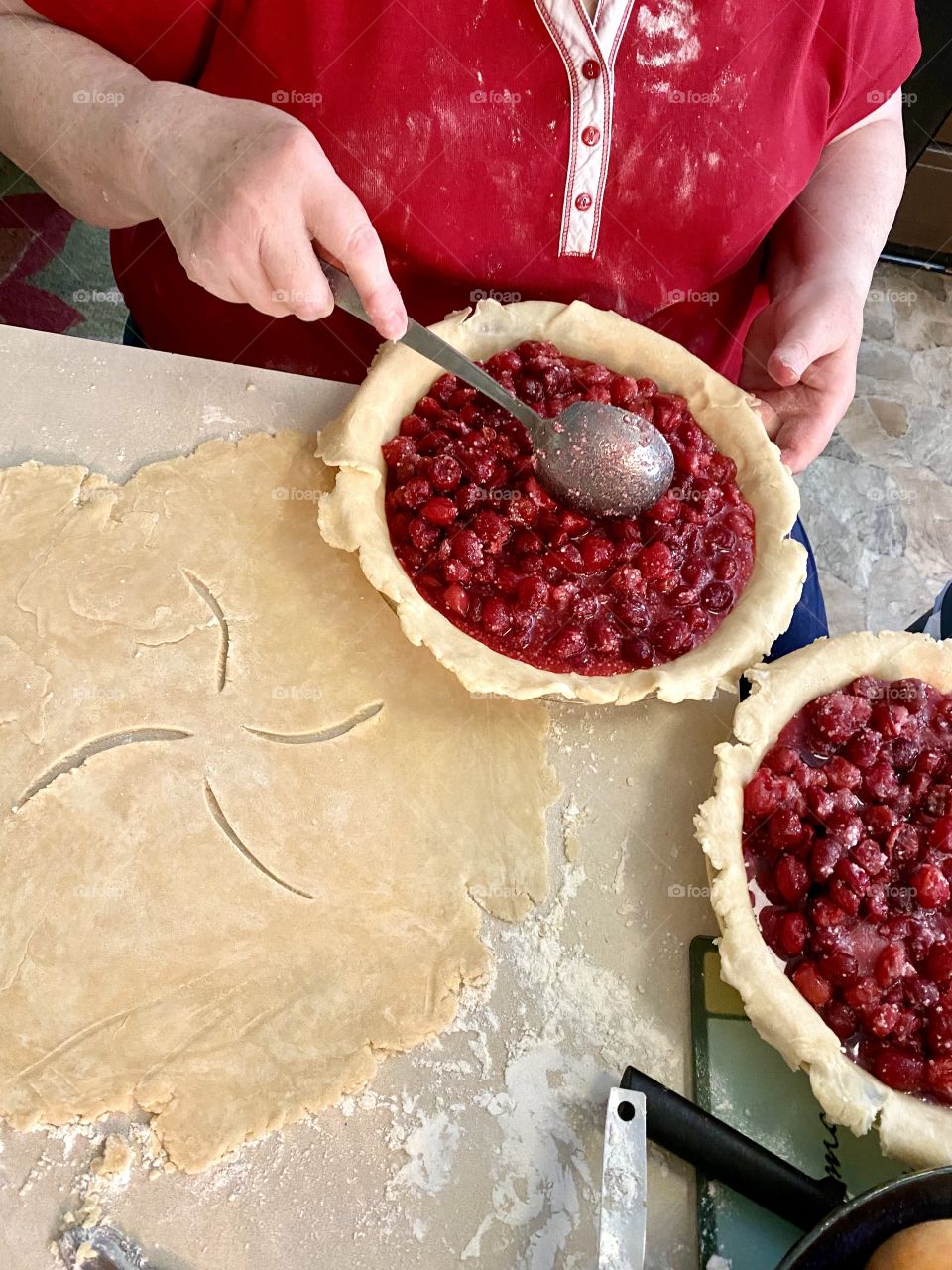 A woman baking a cherry pie