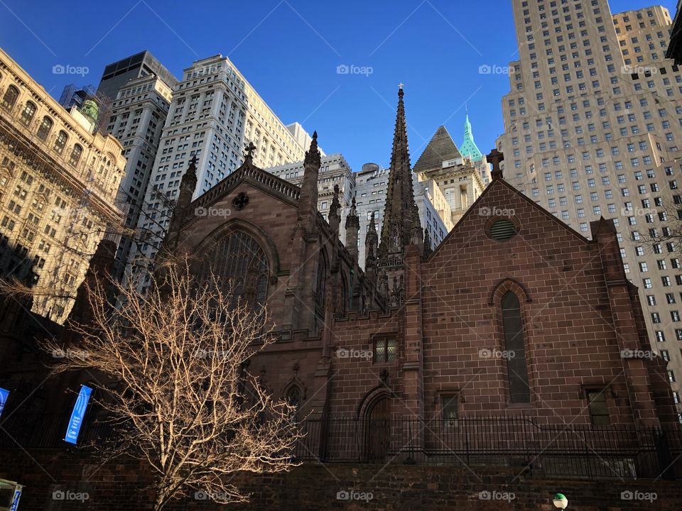 Trinity Church, in Manhattan - New York. A beautiful rustic architecture in the middle of modern and beautiful skyscrapers.