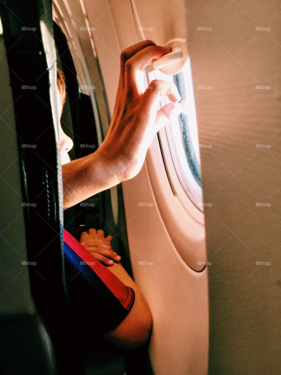 Boy in an airplane by the window 