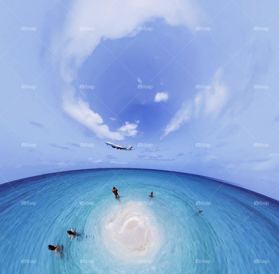 Plane flying over swimmers tiny planet 