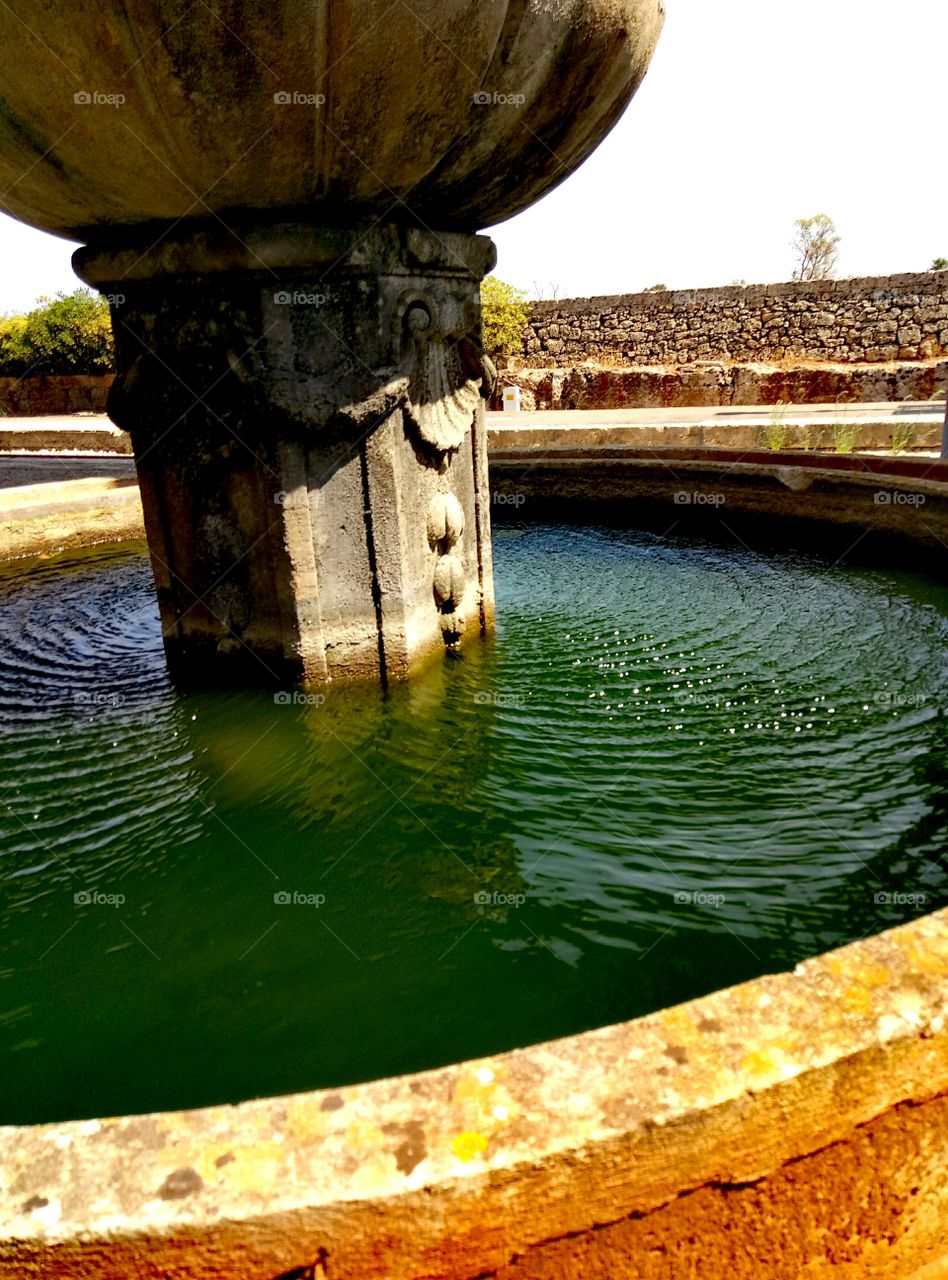 Ripples on water, closeup. Fountain at the train station of Presicce, Italy